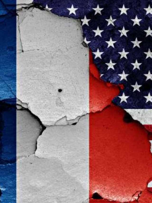 flags of France and USA painted on cracked wall